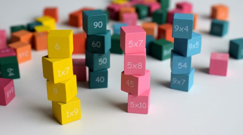 Stack of colored wooden cube with digits and math facts printed on them